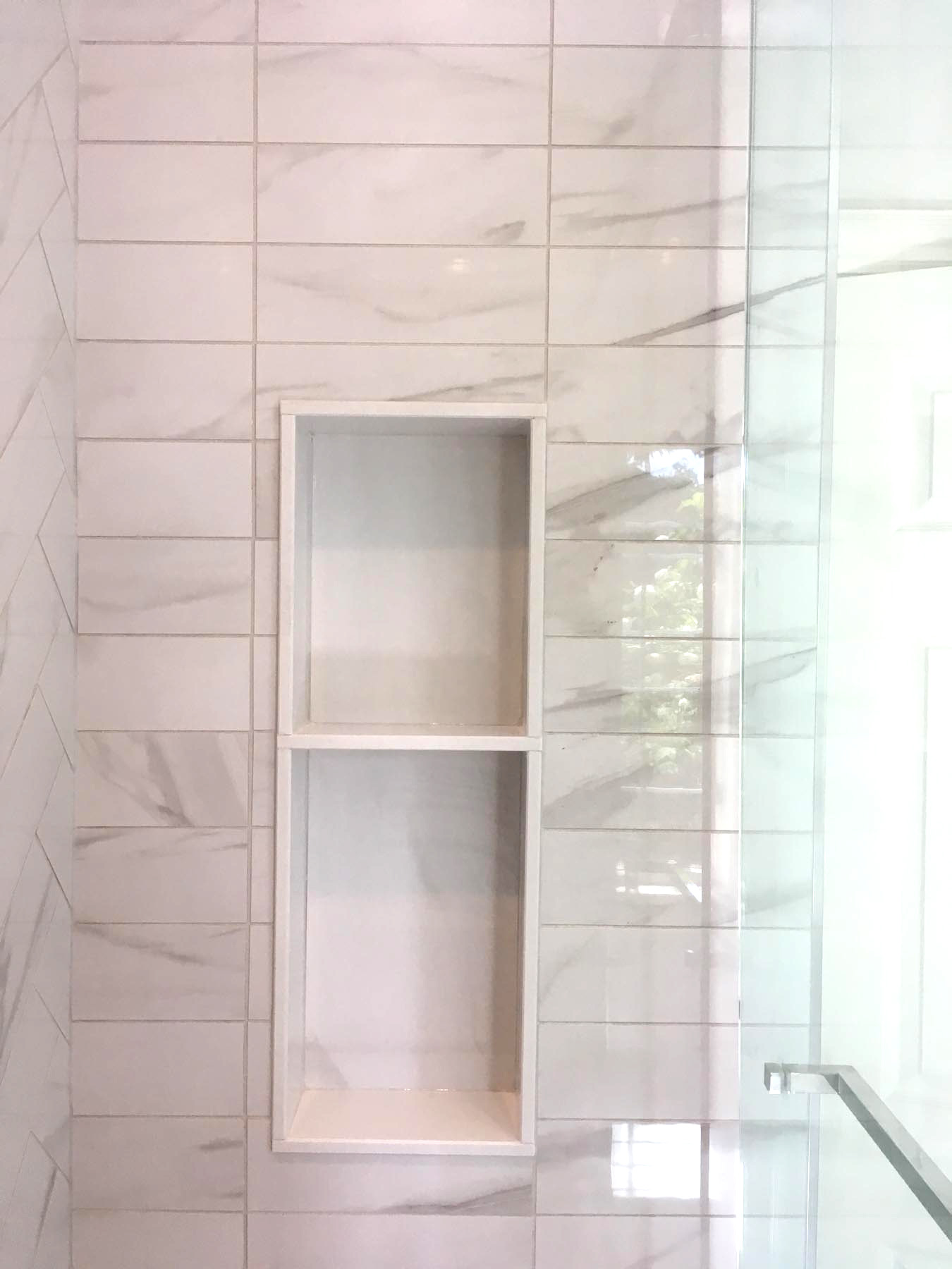 built-in shower storage done in marble